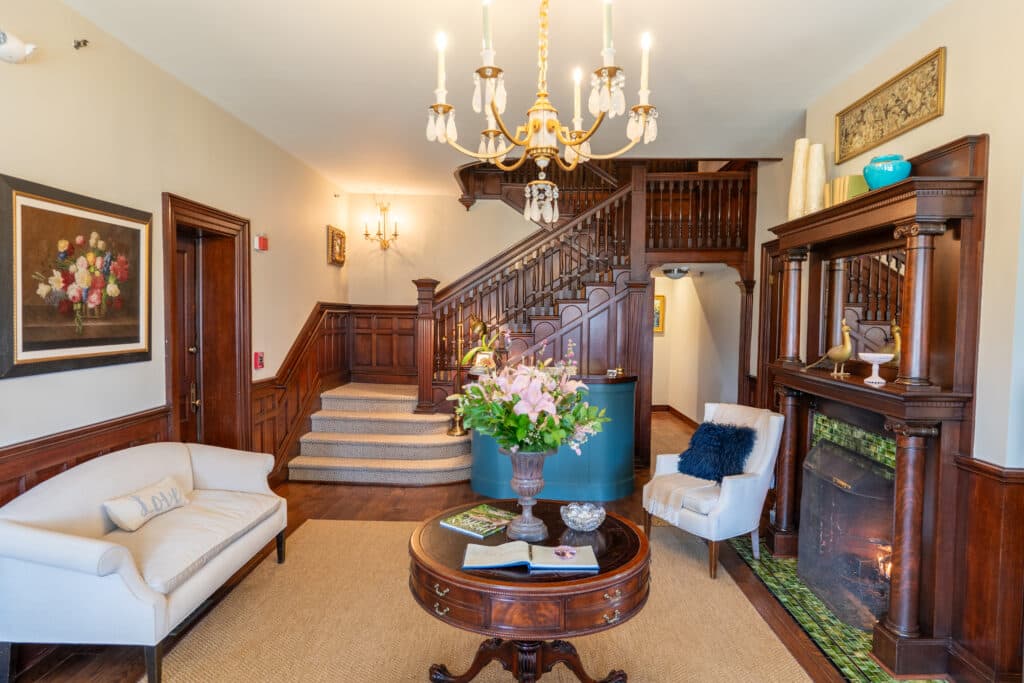 West Lane Inn lobby with grand staircase and chandelier
